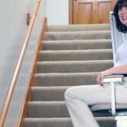 Woman ascending in stairlift