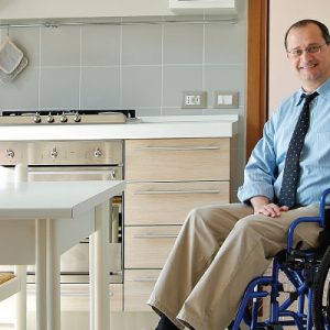 Smiling Man in Wheelchair in His Own Kitchen