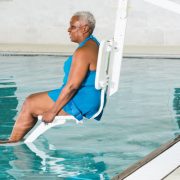 Women Descends Into Pool Using Pool Lift