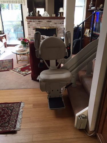 Titone Project: Stairlift at bottom landing, arms raised.