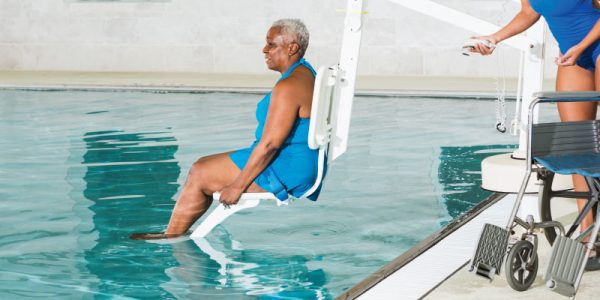 Women Descends Into Pool Using Pool Lift